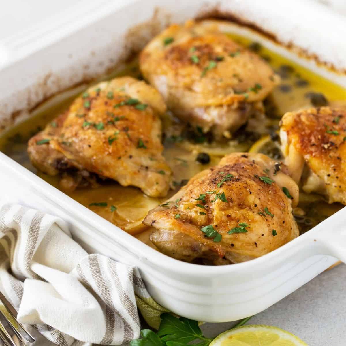 Crispy Baked Chicken Thighs with Capers - Garnish with Lemon