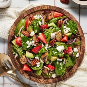 Strawberry Chicken Salad on a wooden plate.