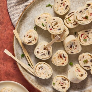 chipotle roll ups on a plate with picks.