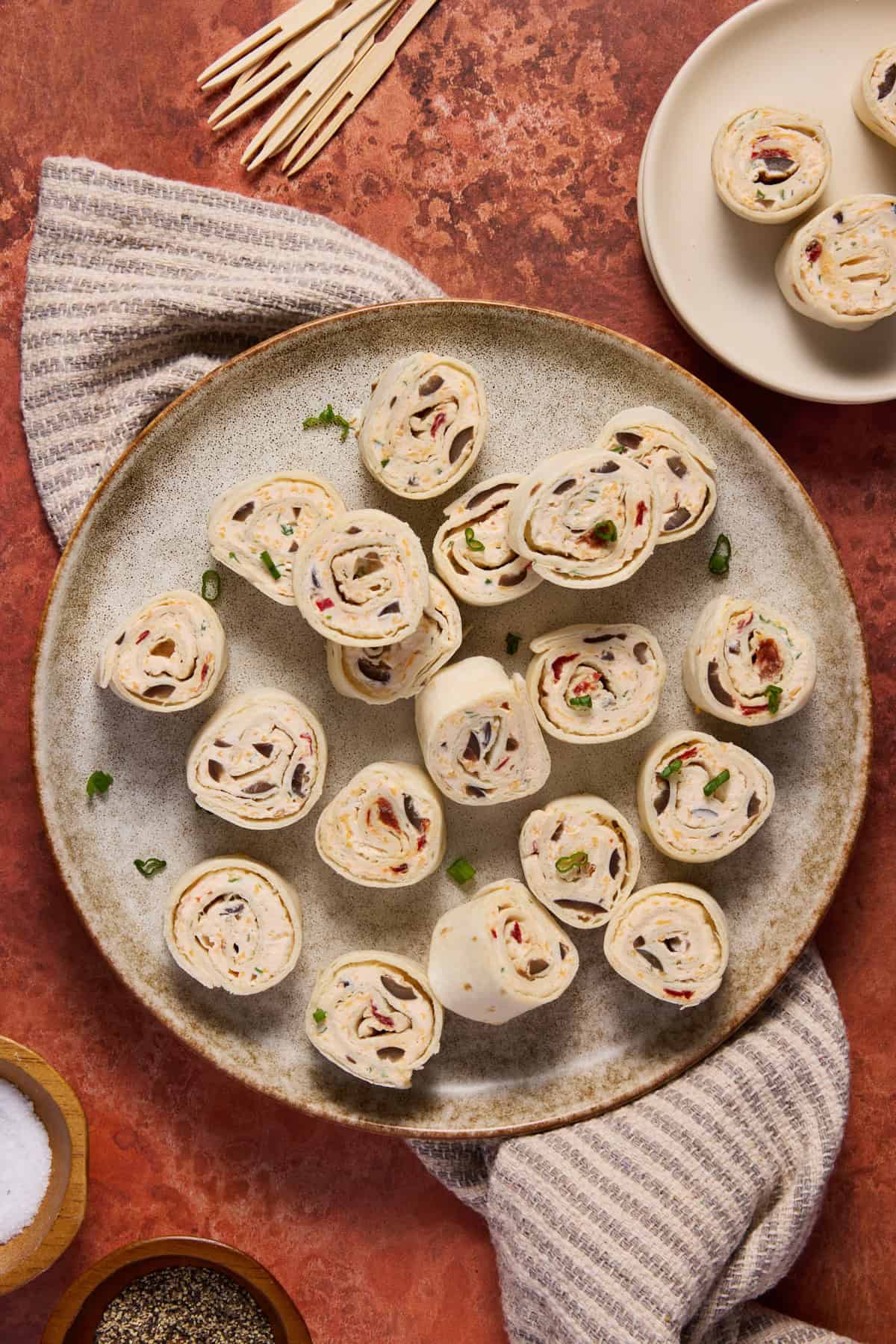 Rolled up tortillas filled and cut on plate.